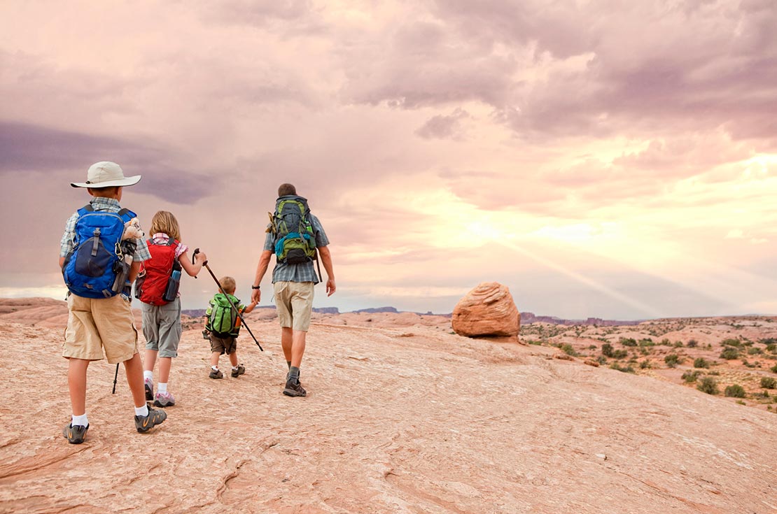 A group of people hiking in a desert