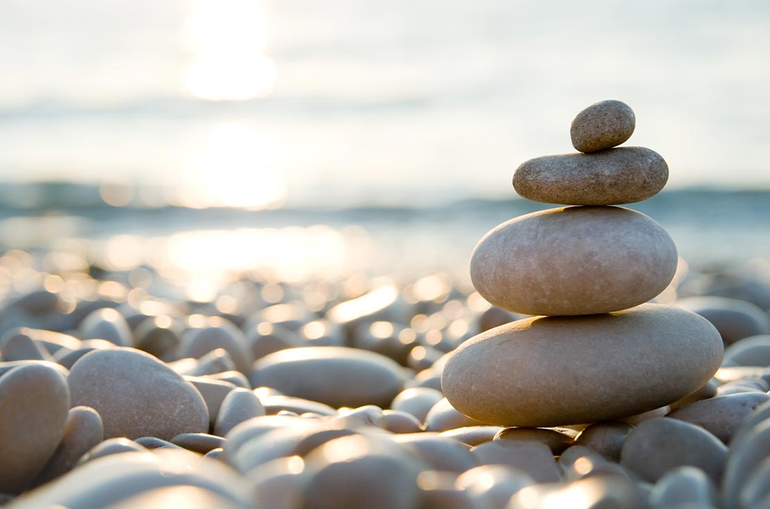 A stack of rocks balancing on a beach